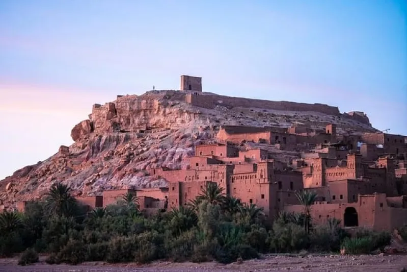  The ancient city of Morocco bathed in warm sunset hues, showcasing its rich history and stunning architectural details at day from Marrakesh 