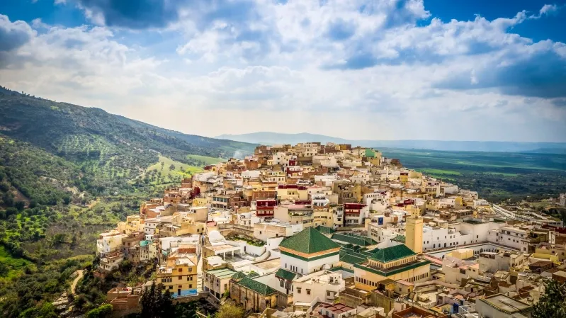 .A panoramic view of the historic city of Fes, Morocco, showcasing its intricate architecture and vibrant culture.While moroccan travel agency