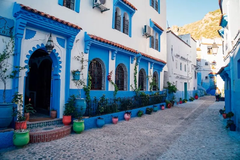 Charming blue and white buildings in Chefchaouen, Morocco, highlighting the vibrant colors and distinctive design of the town.While visit chefchaouen