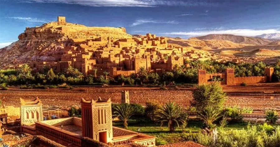 A panoramic view of a Moroccan city, showcasing its unique architecture and vibrant atmosphere under a clear blue sky.While travel trips