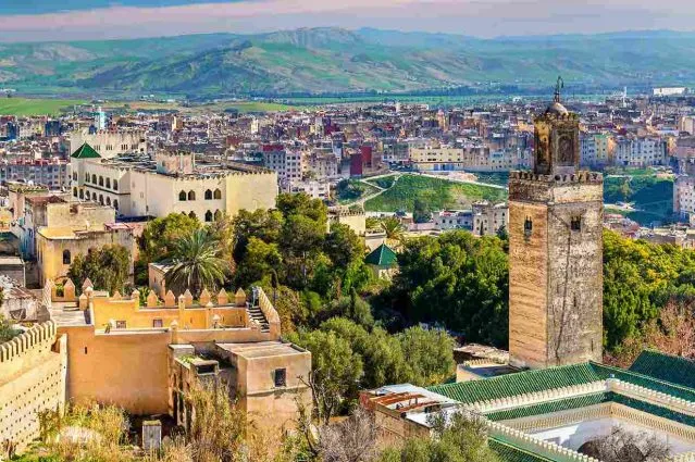fzs, Morocco, showcasing vibrant markets, historic architecture, and the Atlas Mountains in the background.7 Days Tour from Fes