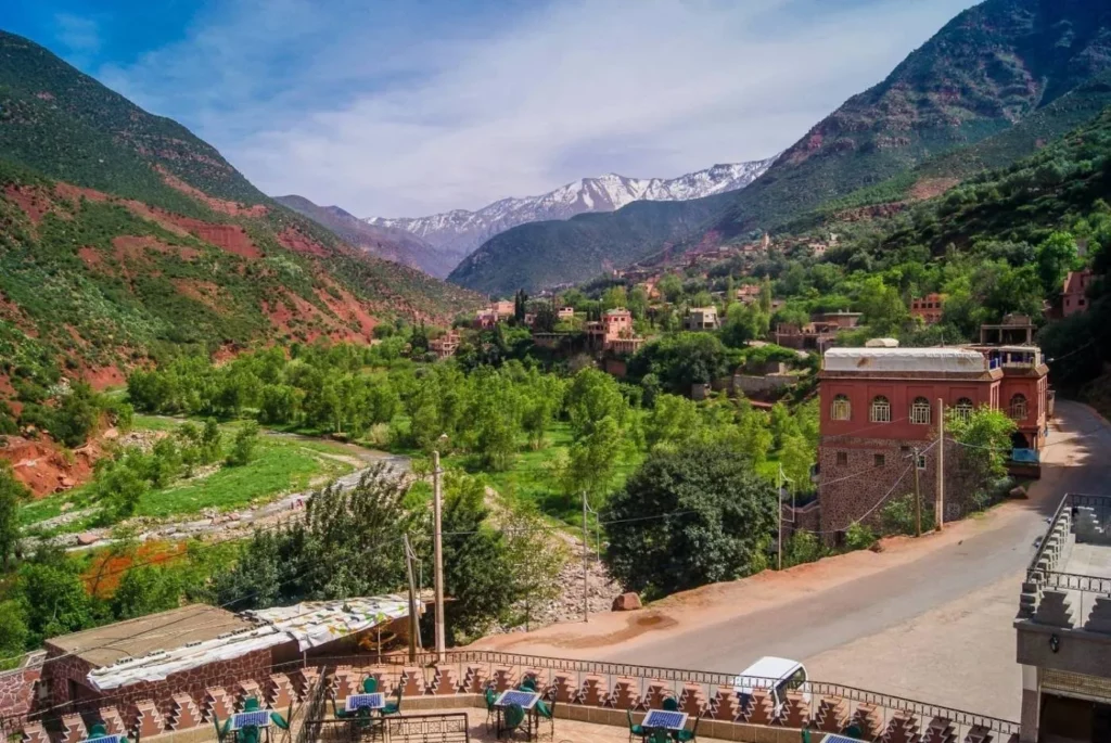 A panoramic view from a Moroccan mountain peak, showcasing vast landscapes and distant horizons under a clear sky in atlas mountains tours and 5 valleys