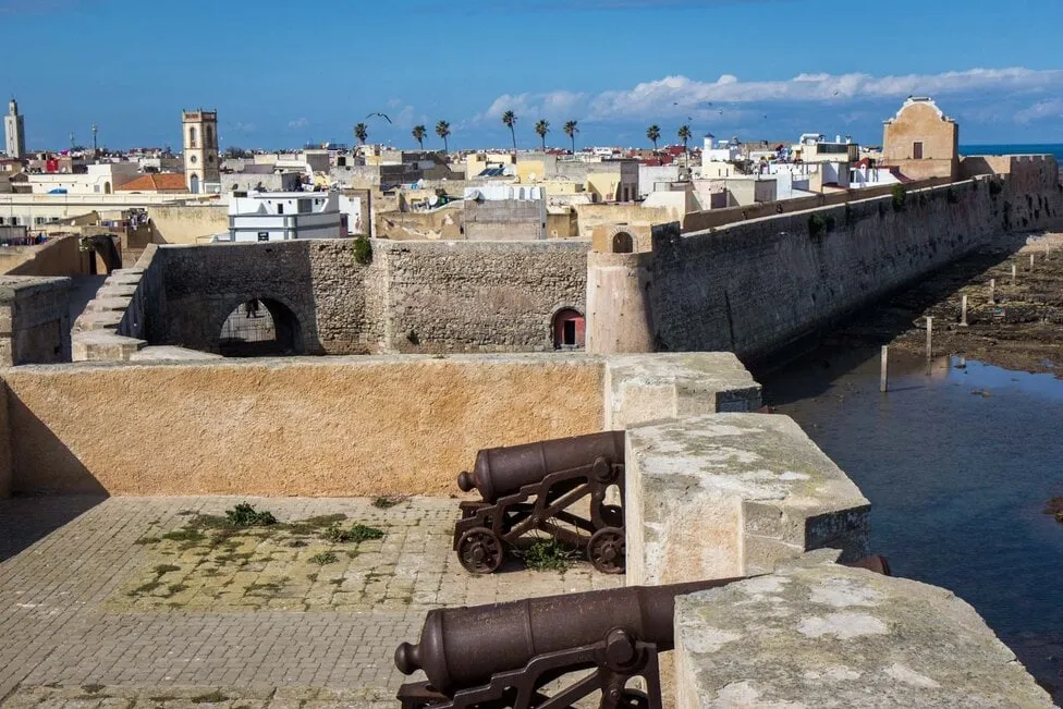 View from the top of the old city wall in el jadida, showcasing historic architecture and vibrant city life below.