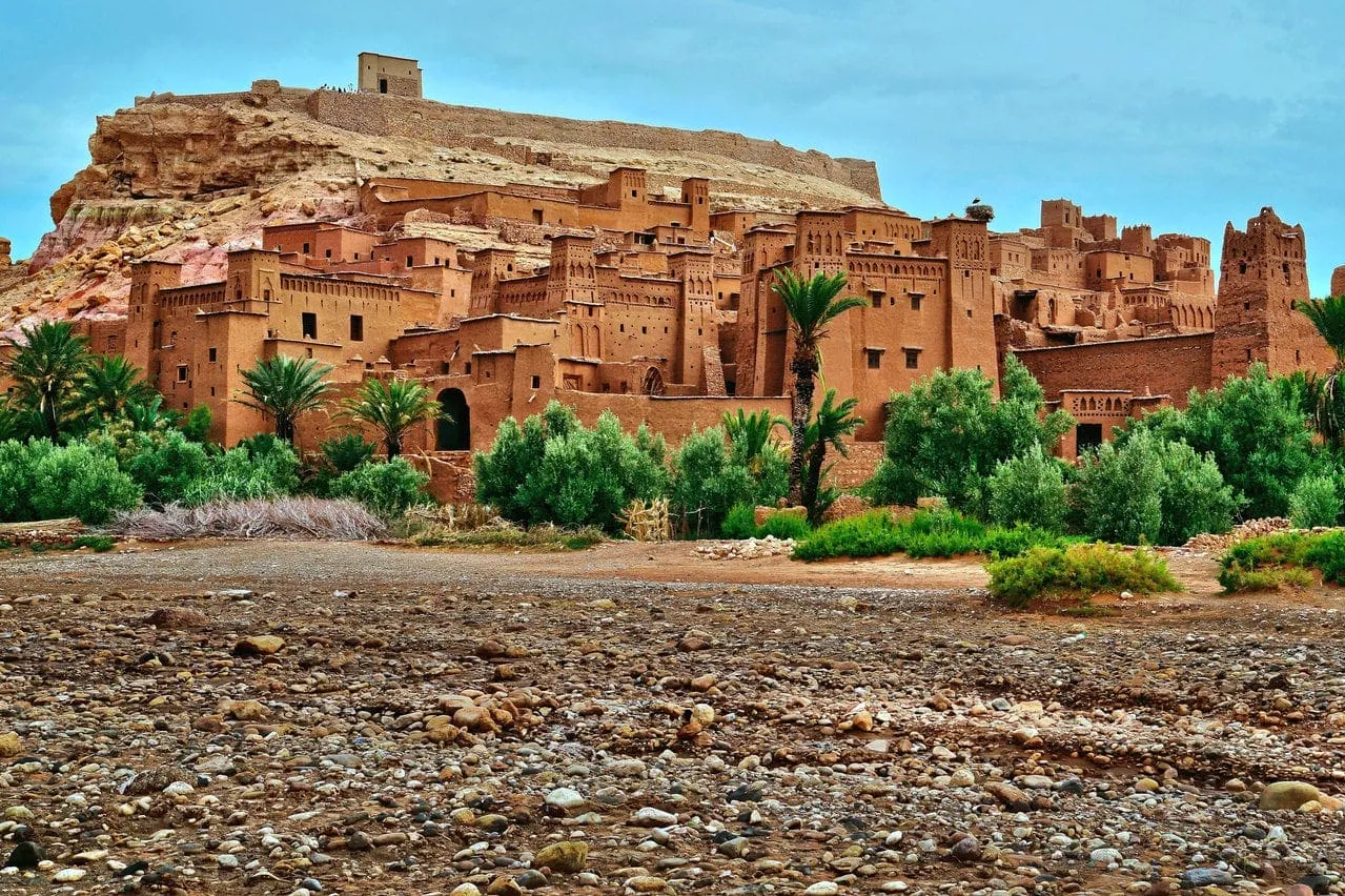 Cityscape of Morocco set against a vast desert landscape, showcasing traditional architecture and arid surroundings.5 Days Errachidia to Marrakech via Desert, Dades & Ouarzazate