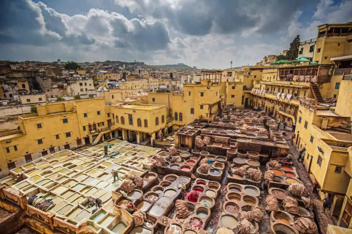 Colorful pots line the streets of a vibrant Moroccan city, showcasing the rich culture and artistry of the region.