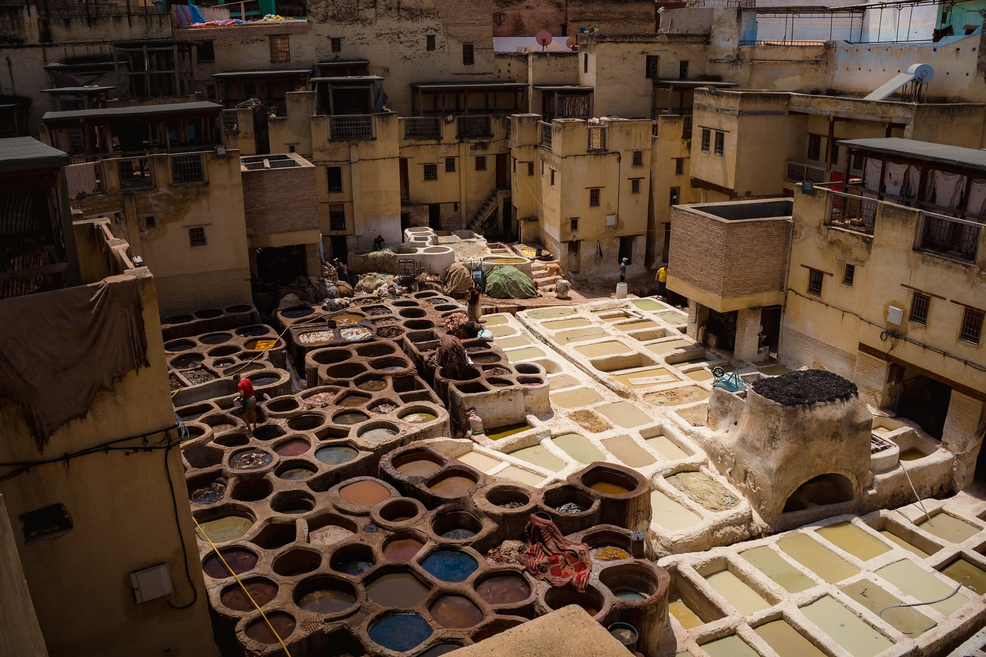 Narrow alleyway in the Fez medina at dawn — the world's largest car-free urban area