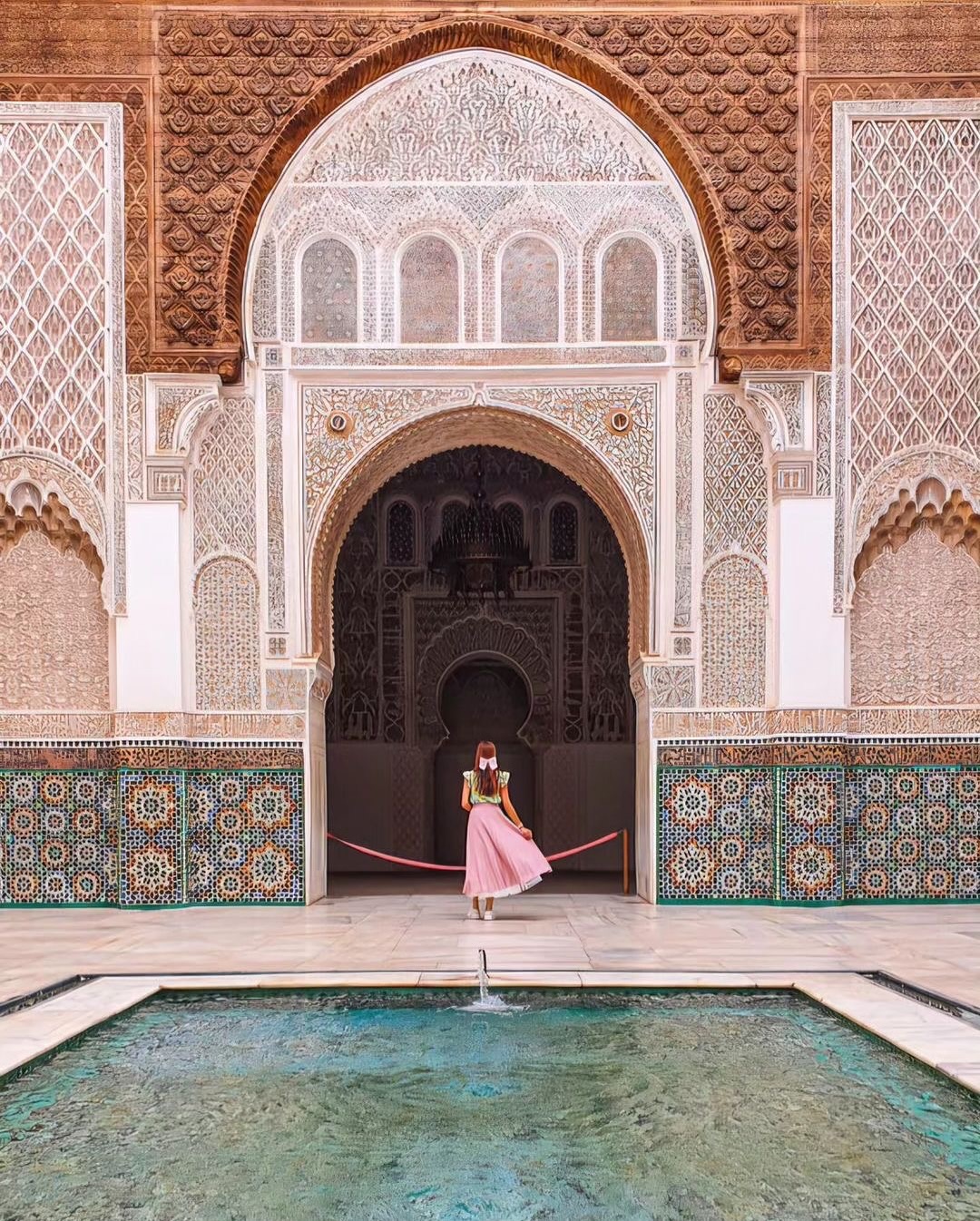 Ben Youssef Madrasa Marrakech central courtyard with carved cedar wood and zellige tilework