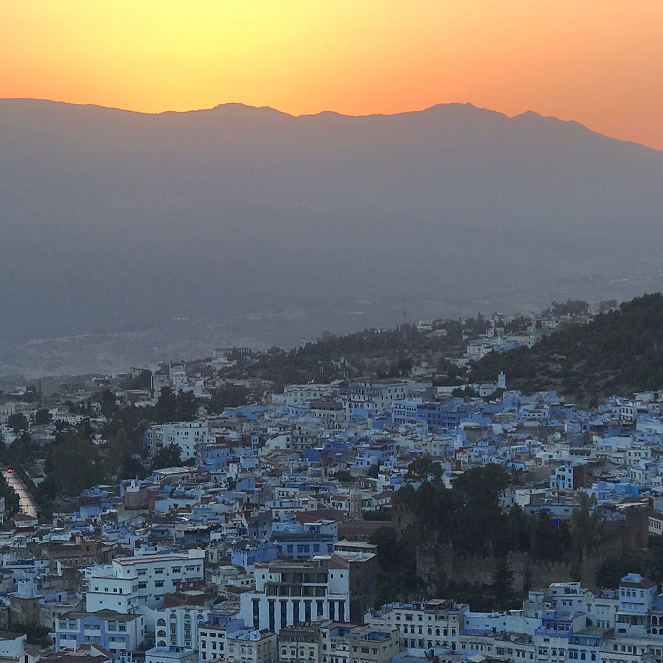 Chefchaouen blue city sunset from Spanish Mosque viewpoint with Rif Mountains