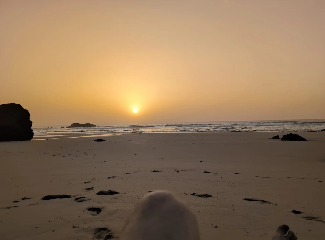 Legzira Beach natural sandstone arches at sunset — southwestern Morocco coast