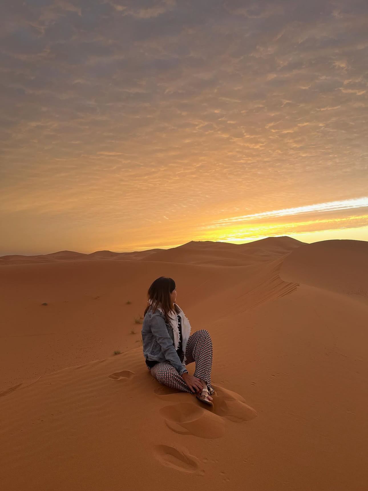 Sahara Desert sunset at Merzouga Erg Chebbi dunes with golden sand transformation