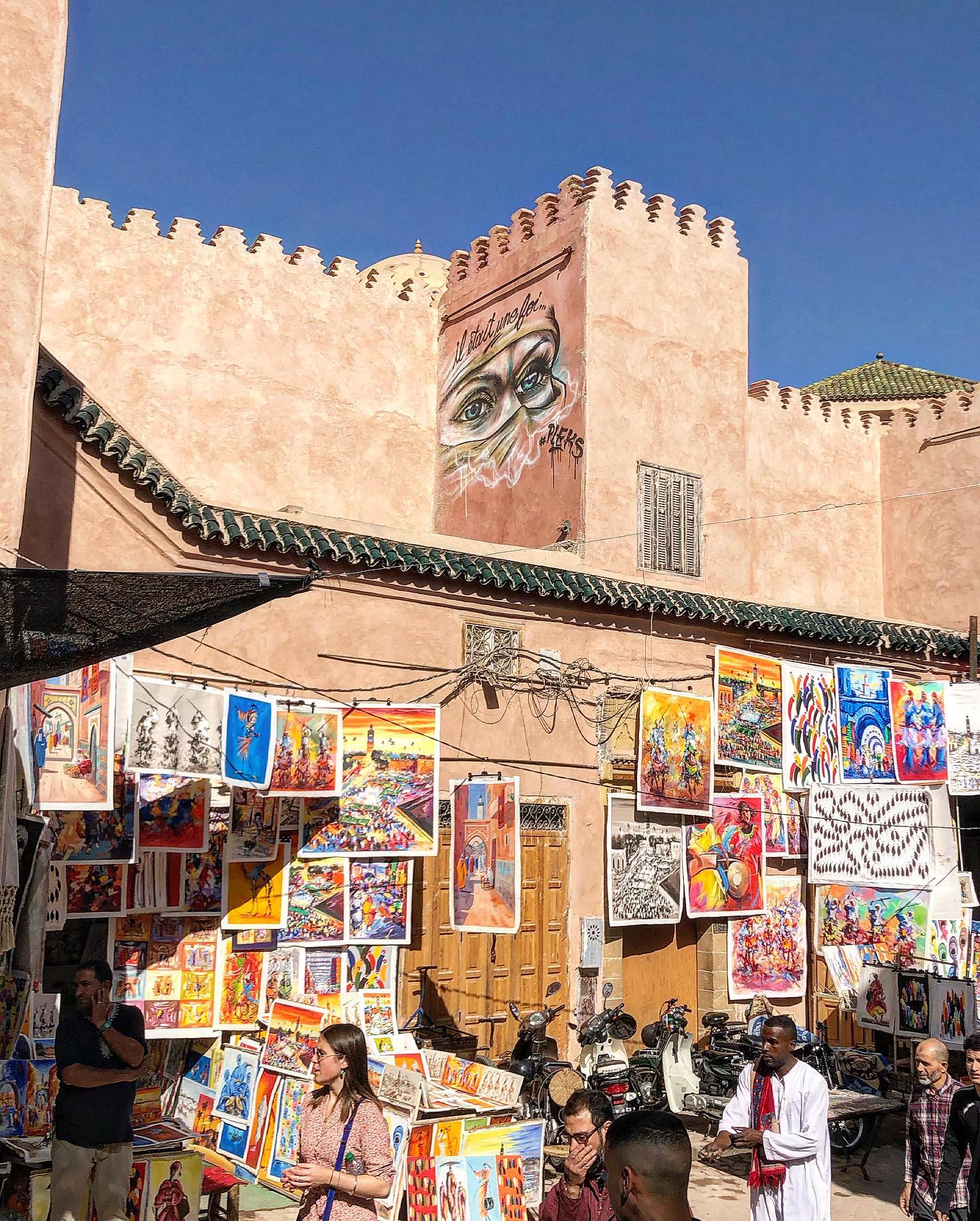 Colourful textiles hanging in a Marrkech souk alleyway