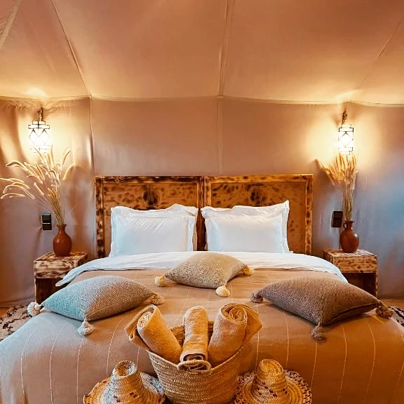 Tent interior king bed desert camp Morocco