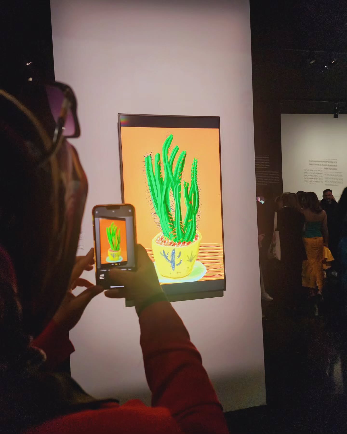 mYSLm Marrakech — dramatic gallery exhibition space with spotlit garments