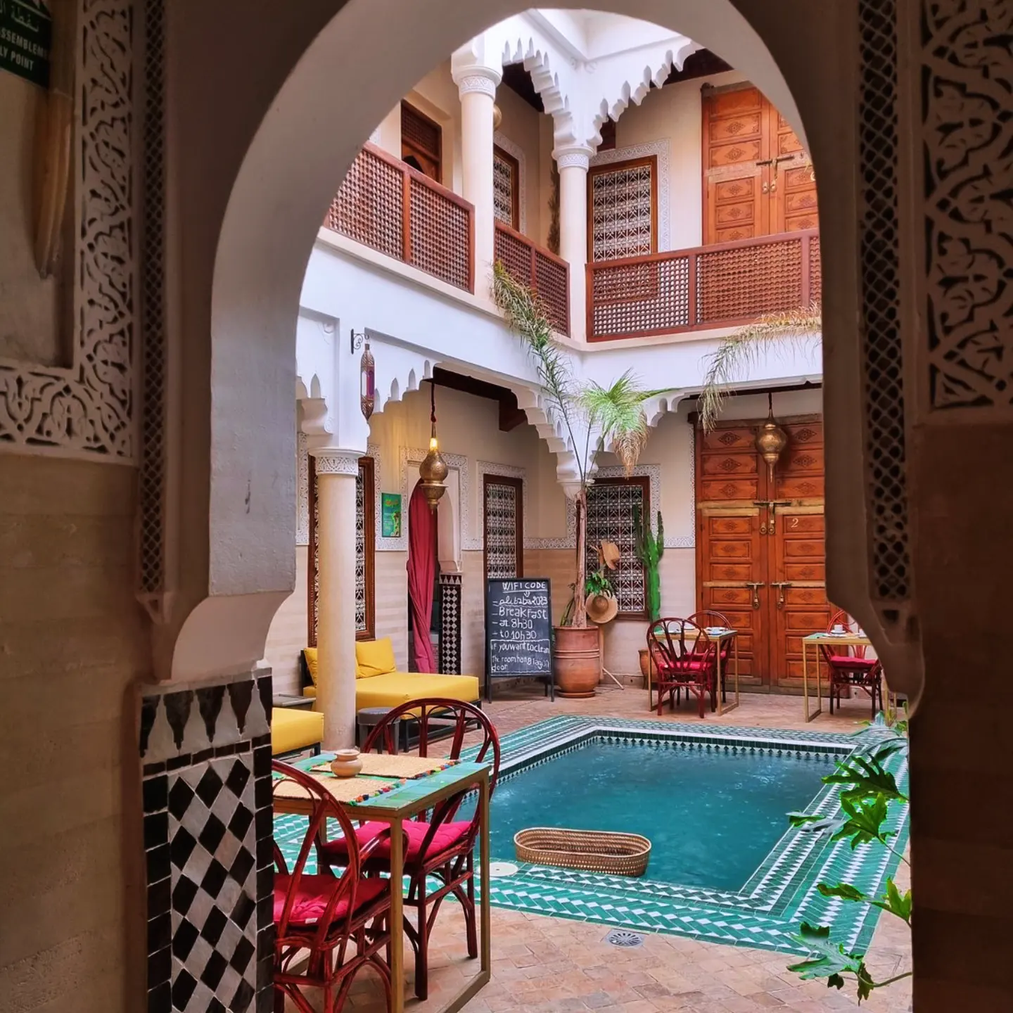 Interior details of a riad in Marrakech showing zellige tiles and fountain