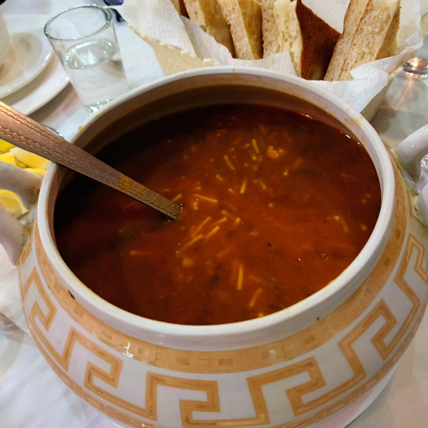 Bowl of harira soup with herbs and lemon
