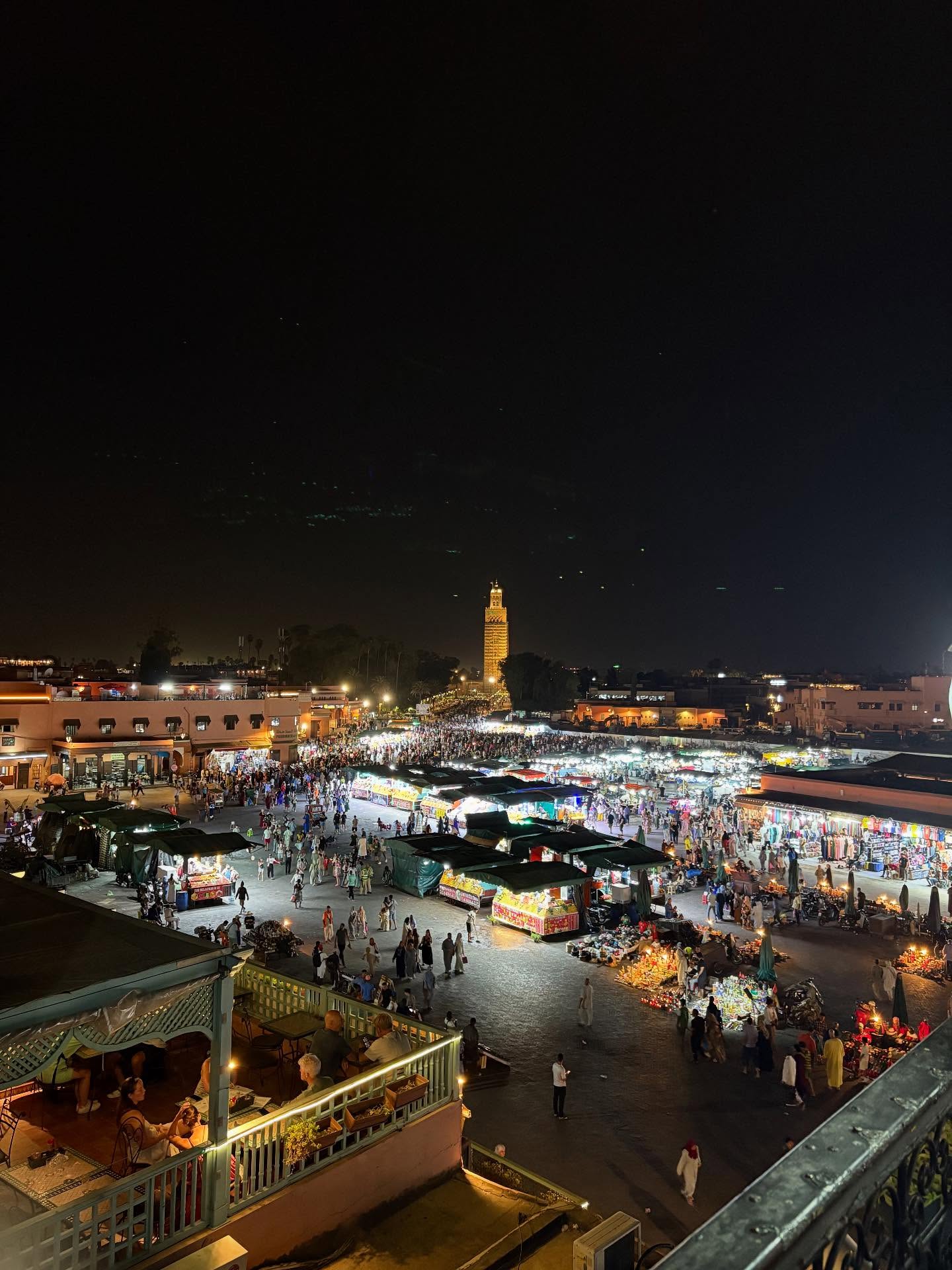 Jemaa el-Fna night market with food stalls, smoke, and crowds in Marrakech