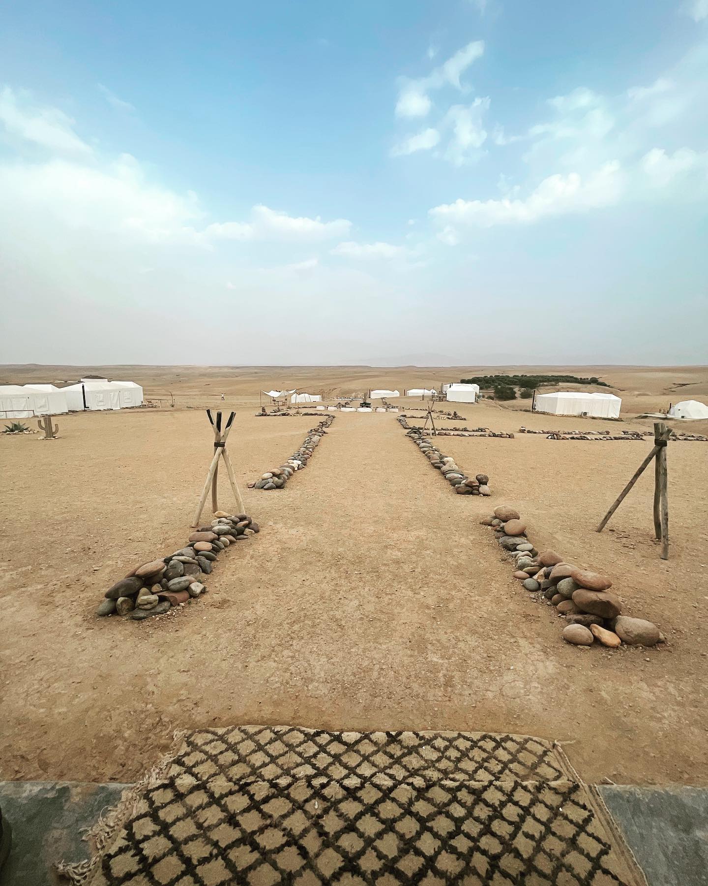 Luxury tented desert camp in Agafay with Atlas Mountains views at dusk