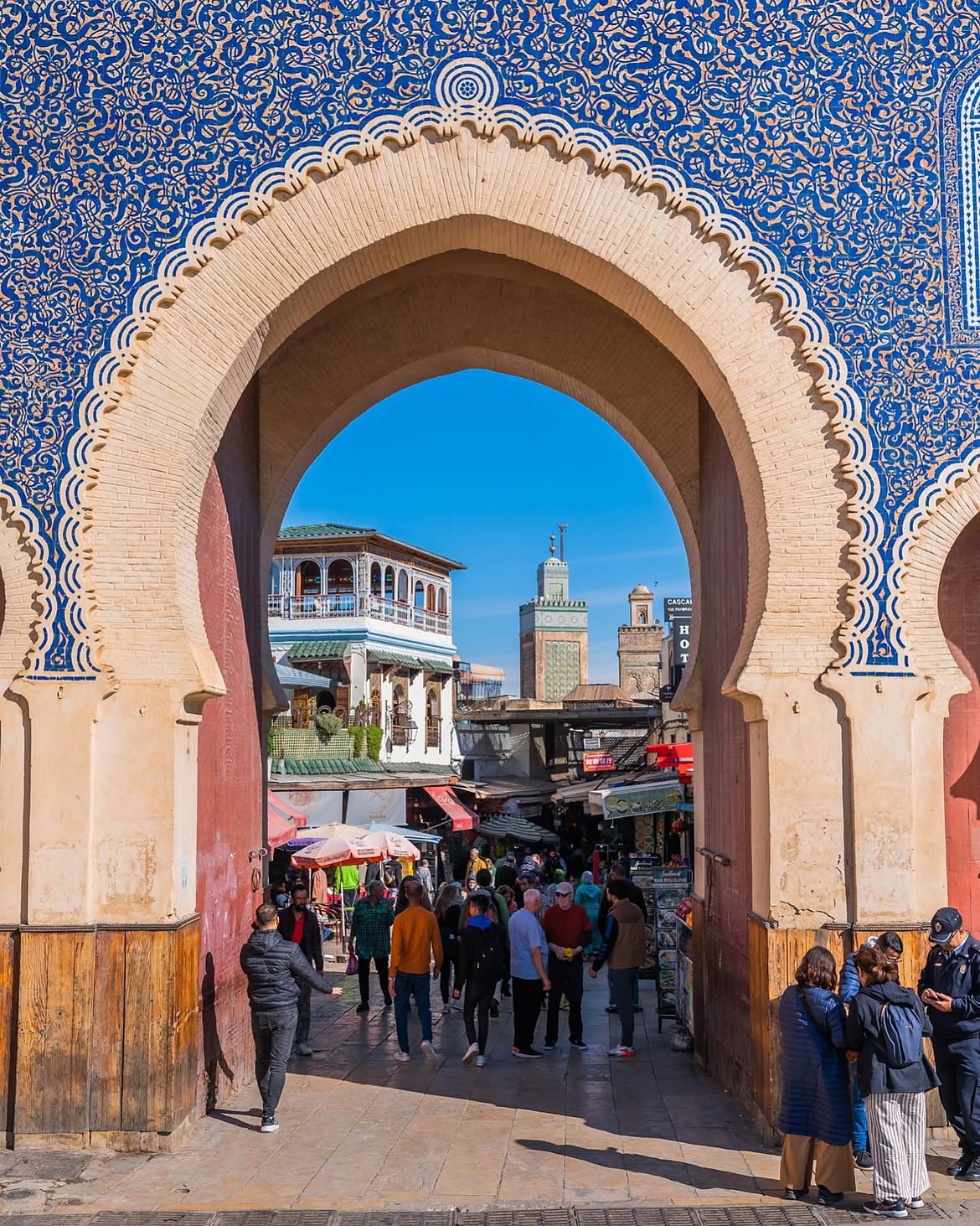 Tourists exploring the narrow alleyways of Fes medina safely with a guide