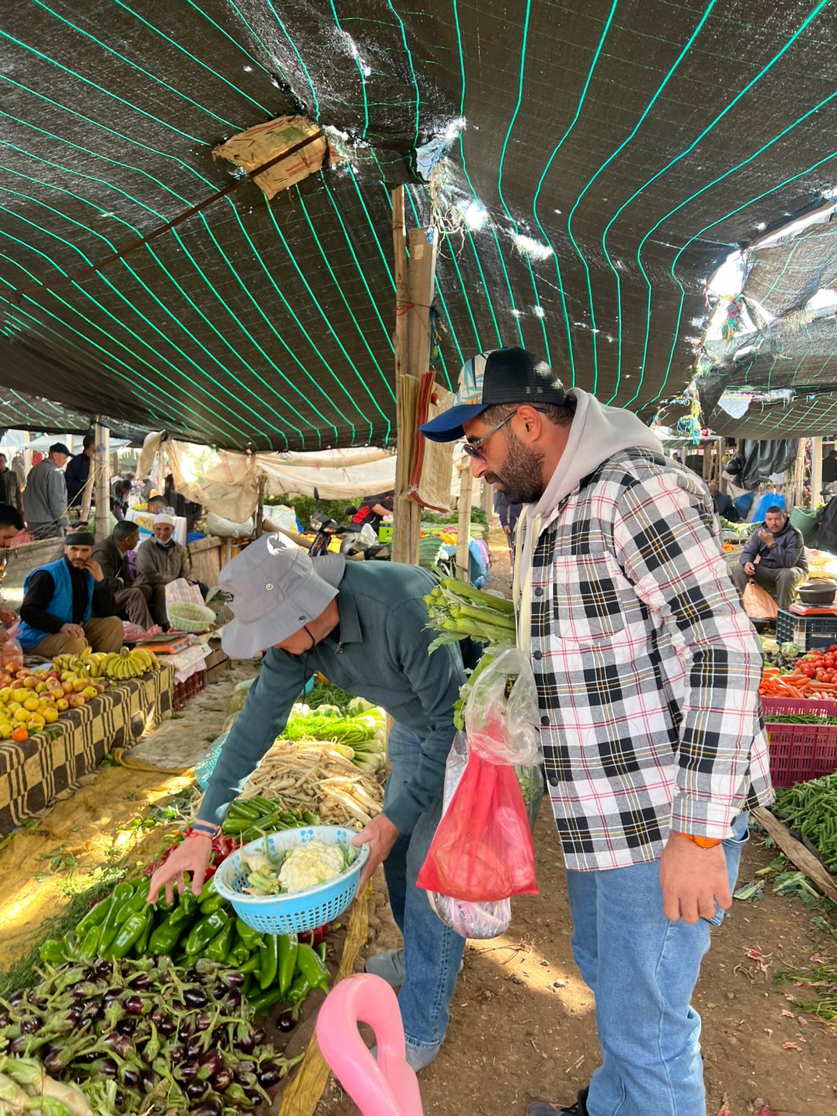 Traditional Moroccan market stall with fresh vegetables, herbs and spices in Marrakech medina