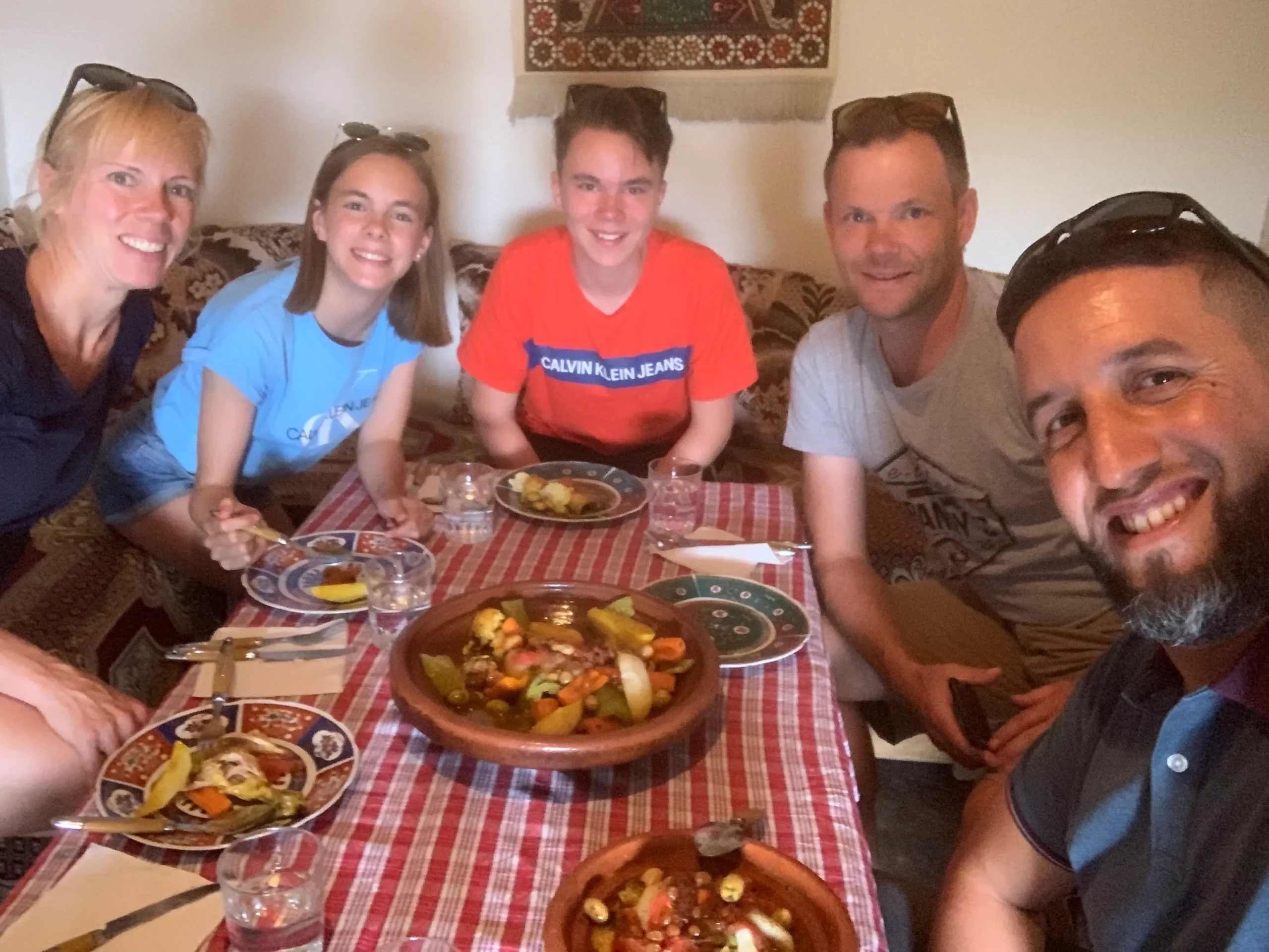 Traditional Moroccan tagine cooking on charcoal — chicken, preserved lemon, olives