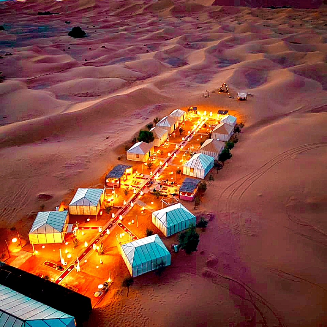 Luxury Sahara desert camp Morocco at night with Milky Way stars