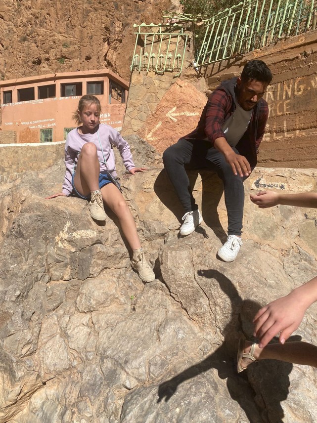 Multi-generational family hiking through Morocco's beautiful countryside together