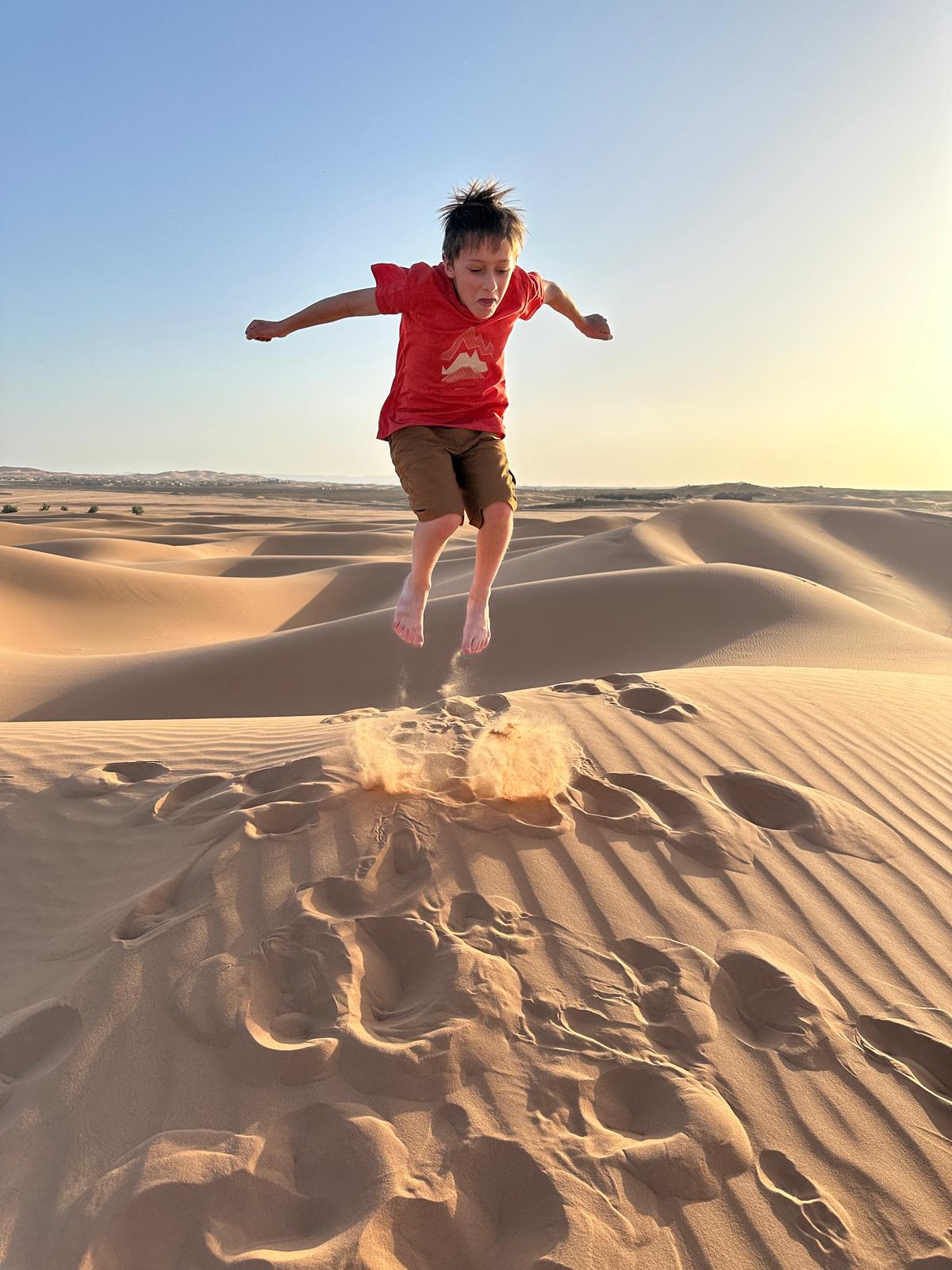 Children laughing and enjoying traditional hands-on activities during a family tour in Morocco
