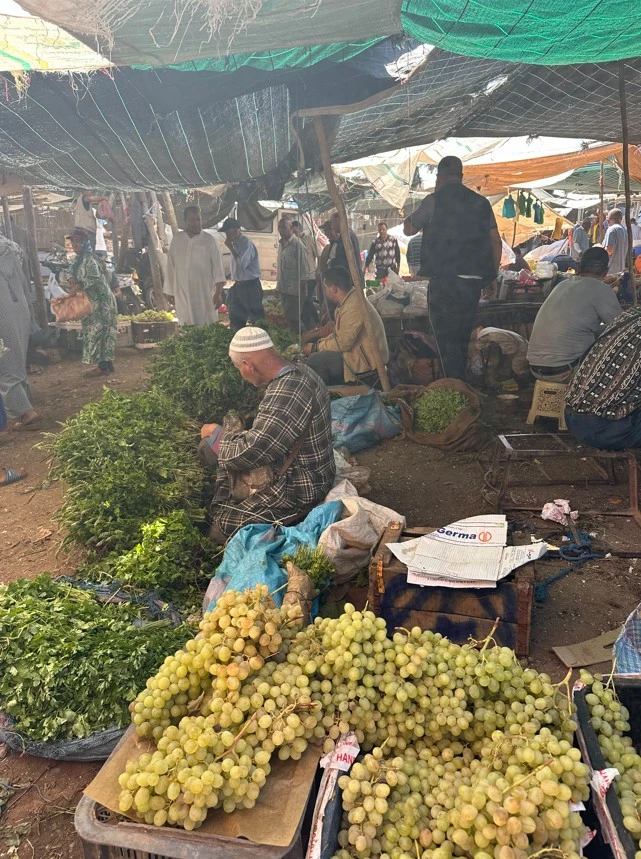 Walking through a traditional Moroccan souk alley with crafts on display
