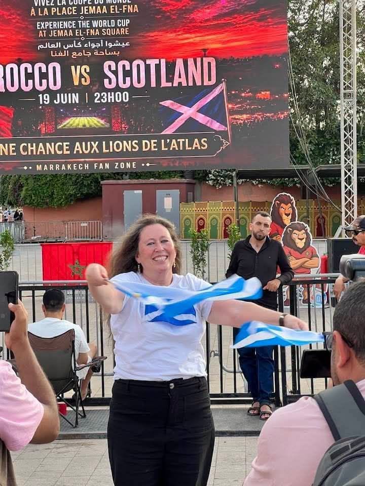 A Scottish fan cheering on her national team at Jemaa el-Fnaa in Marrakech during a Morocco match