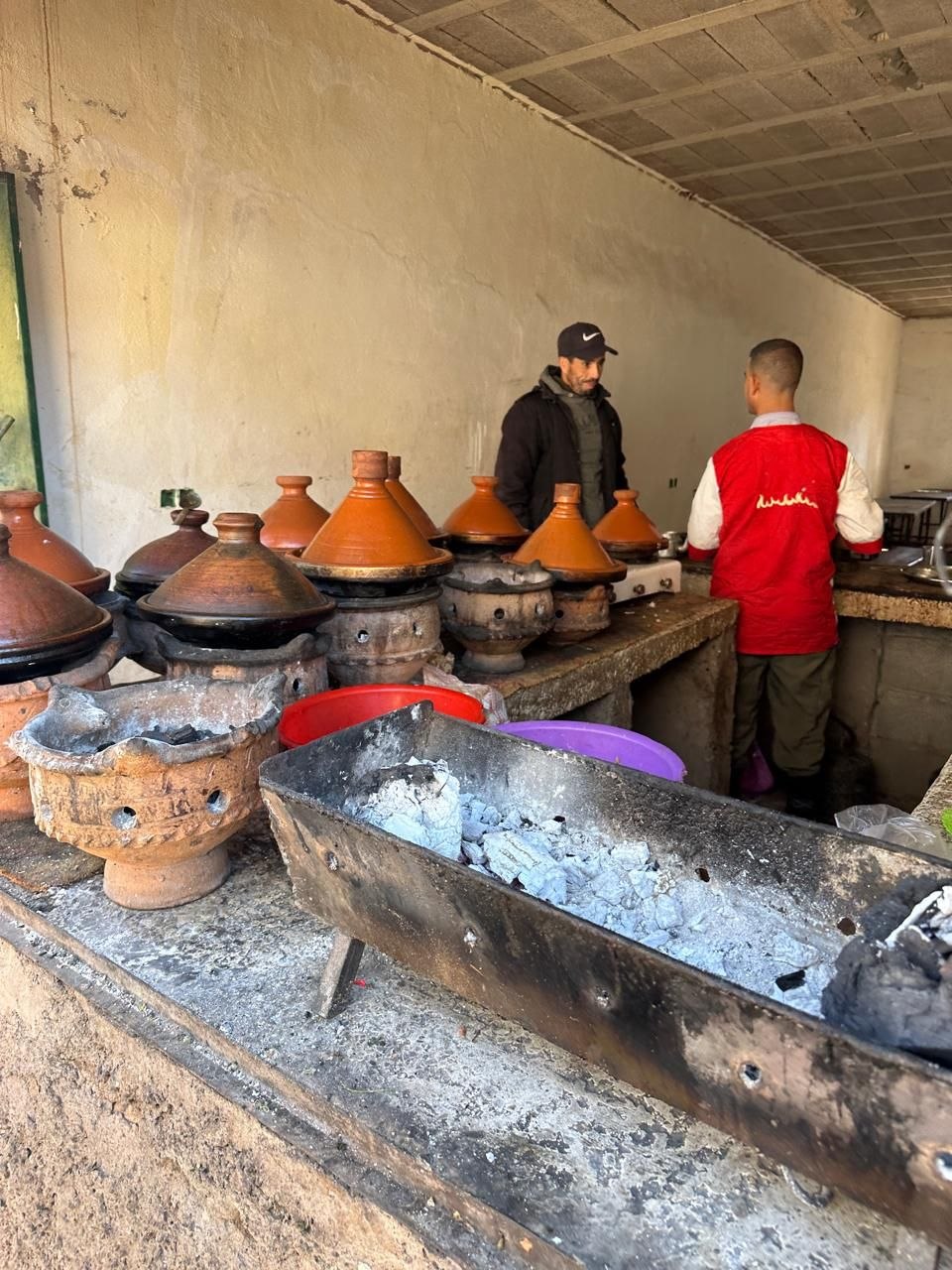 Travelers eating a traditional Berber tagine in the Asni souk