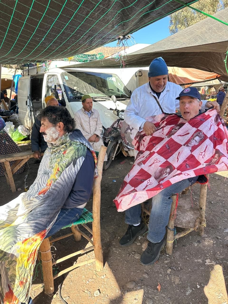 Traveler getting a traditional haircut at the weekly souk in Asni