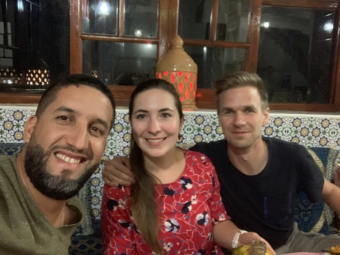 Licensed guide Mouhssine ELIOUJ with honeymoon couple at a restaurant in Marrakech Morocco