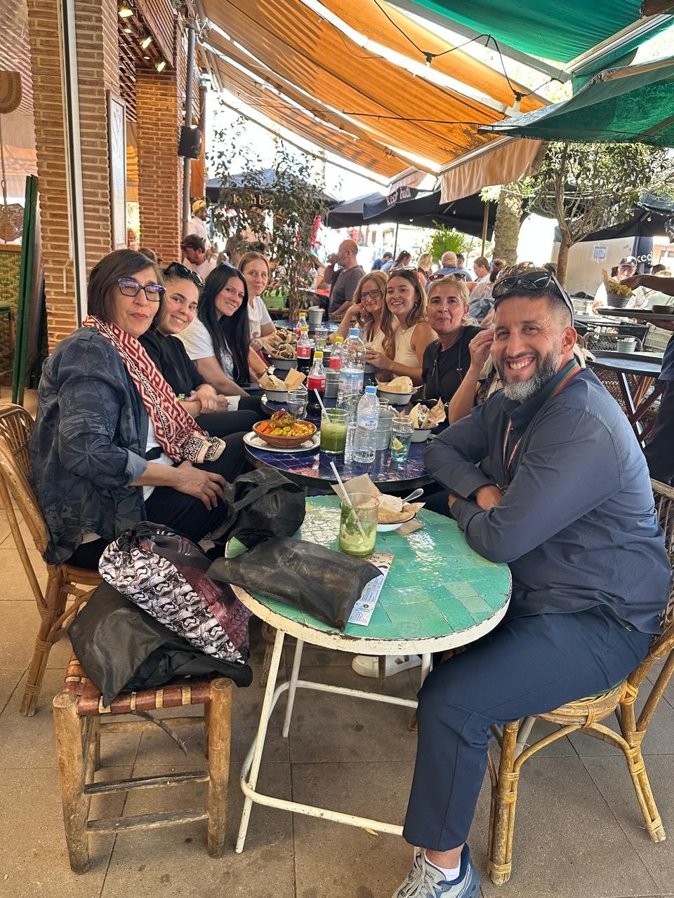 Licensed guide Mouhssine with tourists inside Mazel Café Marrakech