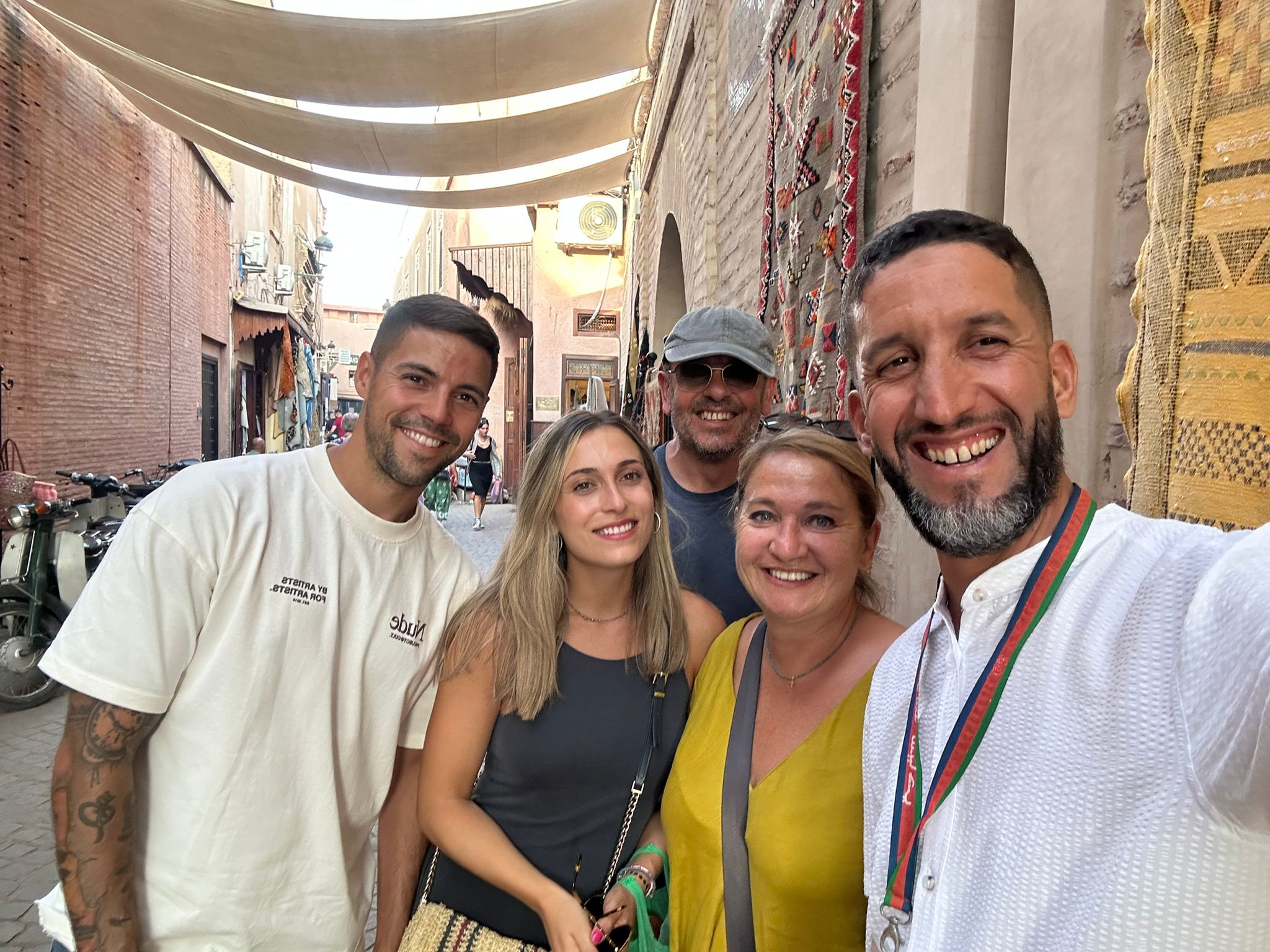 Mouhssine ELIOUJ – licensed Marrakech private tour guide with tourists in the medina