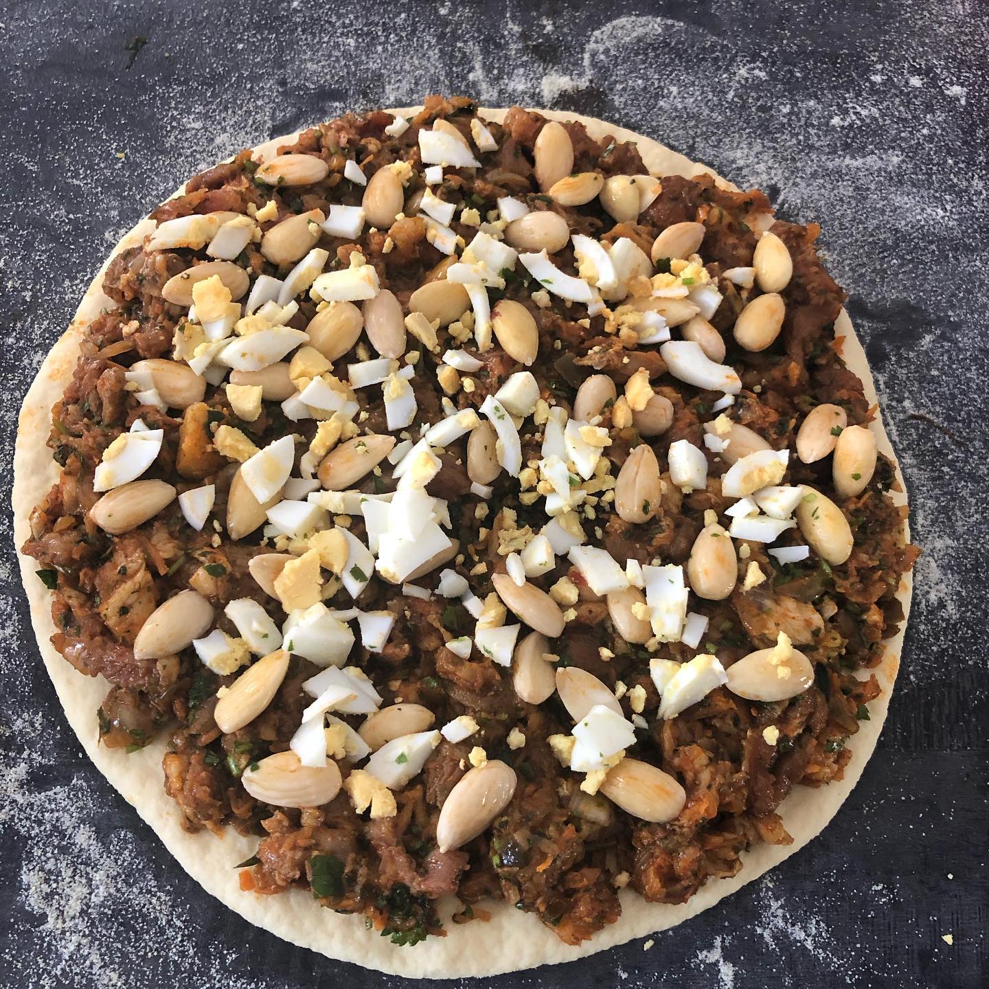 Madfouna ingredients traditional Berber Pizza Morocco spices meat eggs almonds