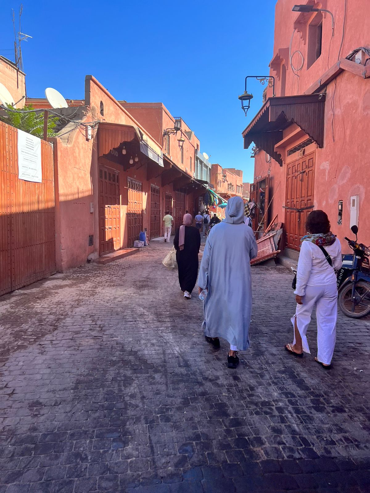 Licensed guide Mouhssine explaining a street in Darb al-Mellah to a visitor