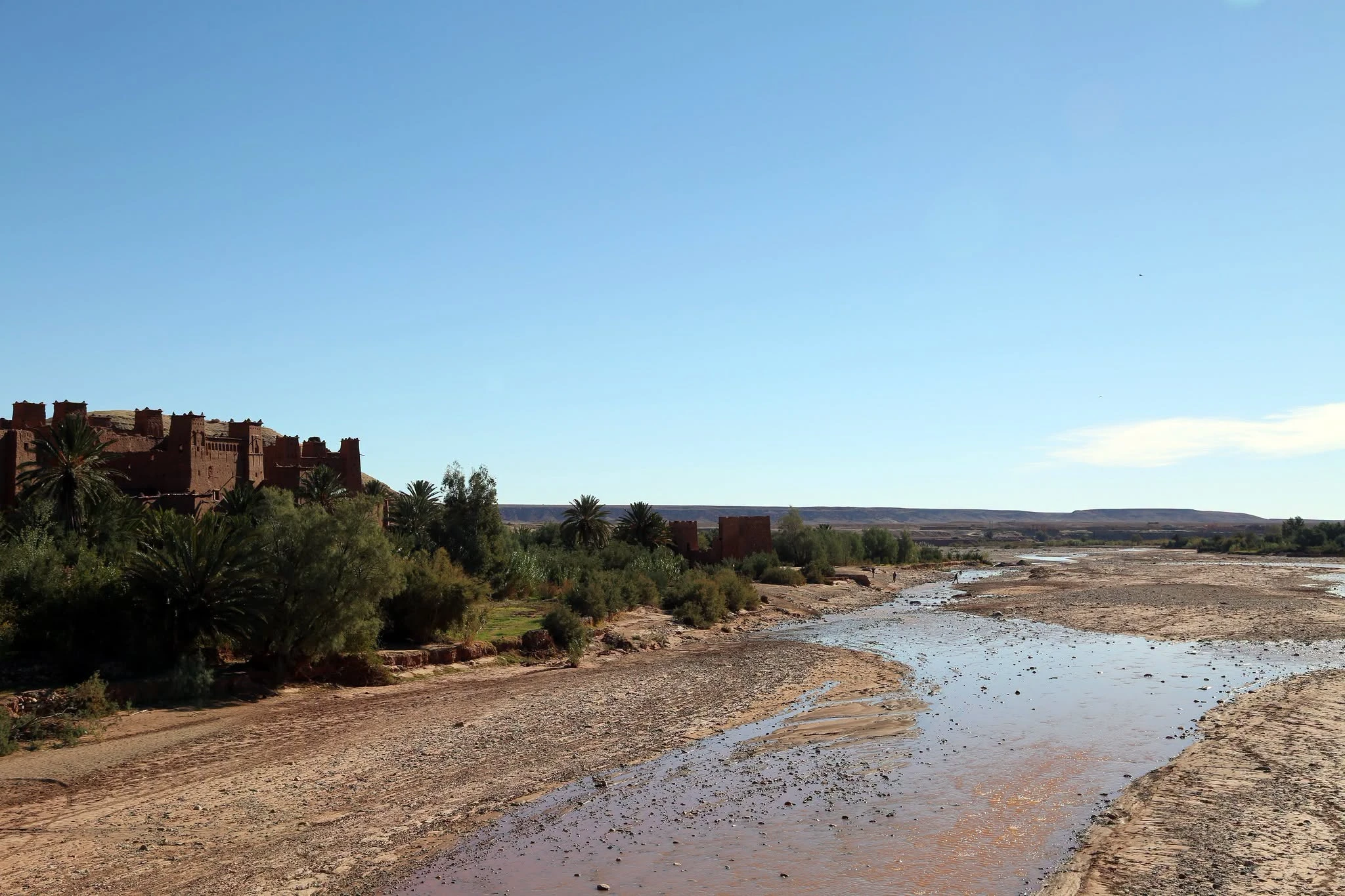 Fortified earthen kasbah of Ait Ben Haddou above the river, seen from the road at late afternoon