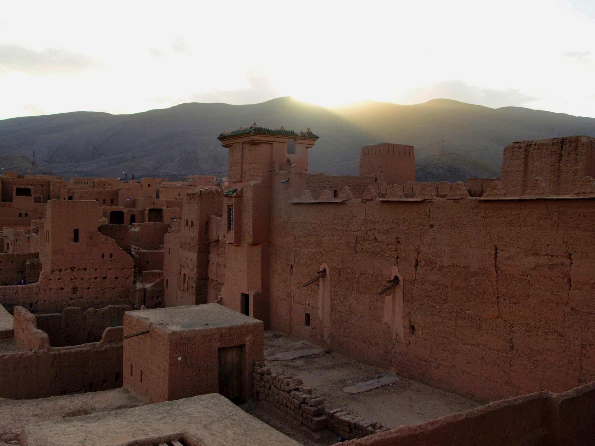 Sunset light on the earthen walls of Kasbah Oulad Othmane in the Draa Valley