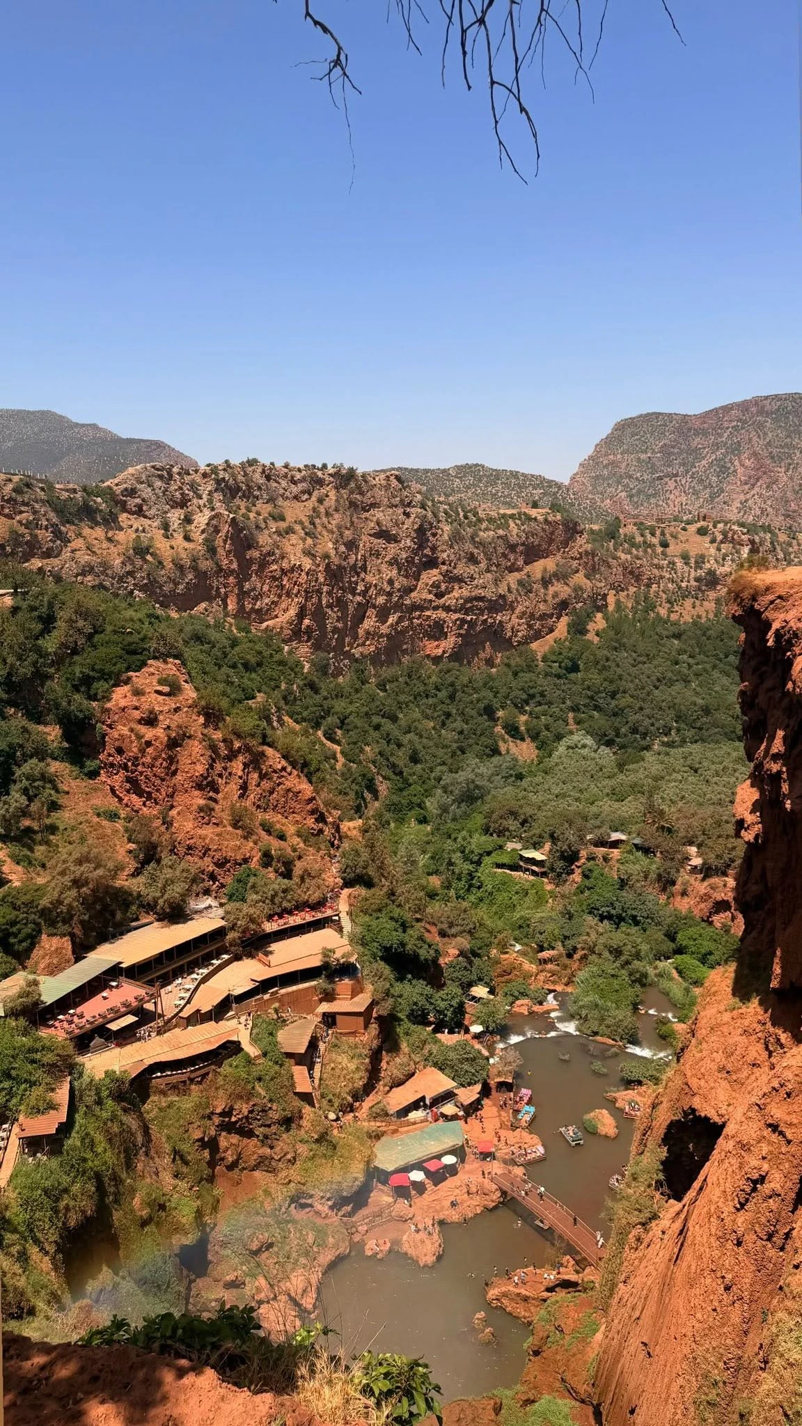 Wide view of the Ouzoud waterfalls dropping through terraced cliffs in the Middle Atlas